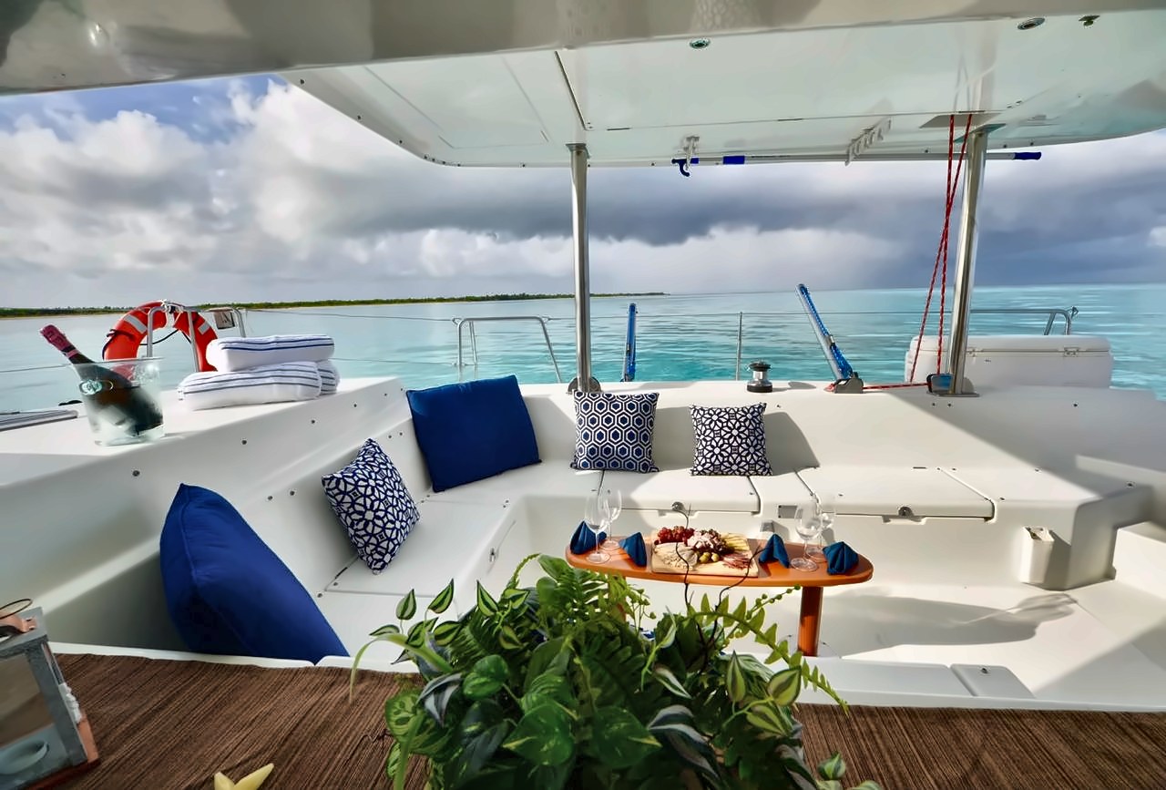 Shaded cockpit lounge with charcuterie on the 44 ft Lagoon Dralion sailing catamaran